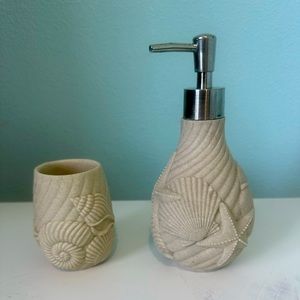 Sea shell bathroom soap dispenser and cup/tooth brush holder.